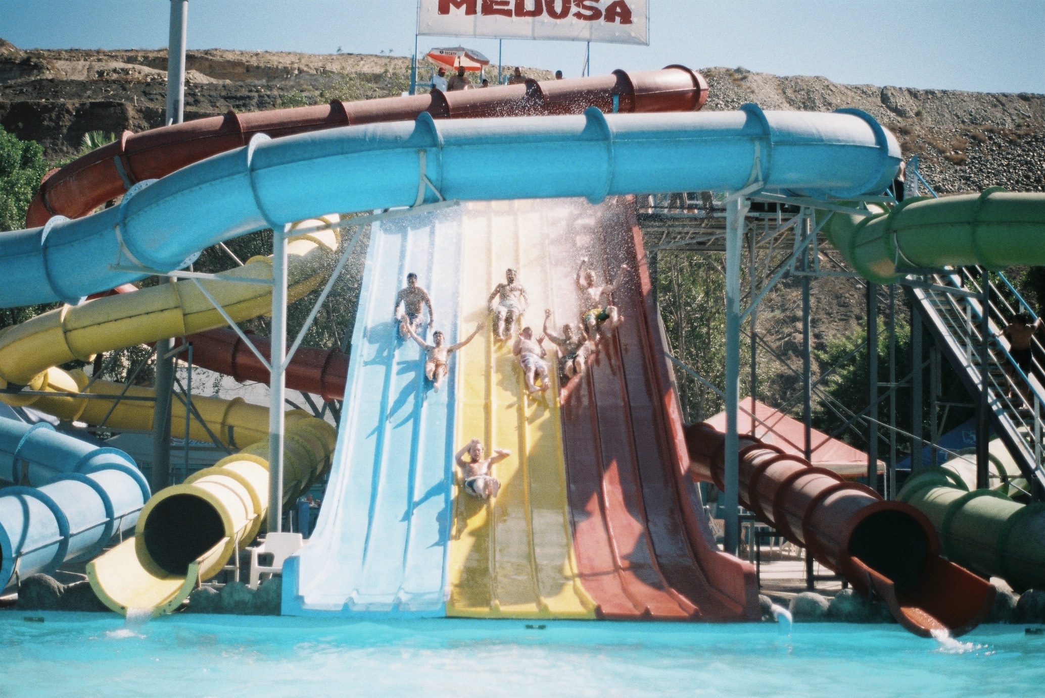 group of people going down a water slide at a water park